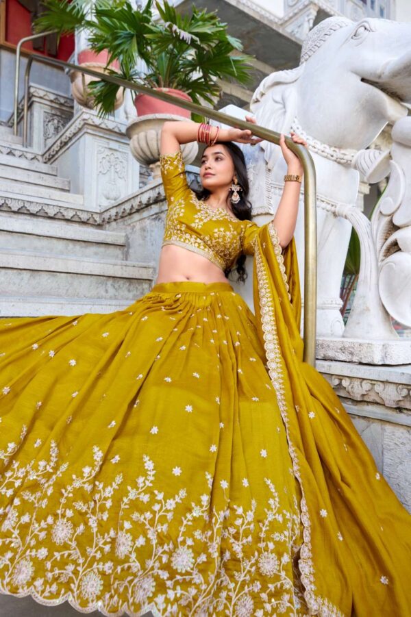 lnb - 1415   lnb 1415 thread embroidery work haldi special lehenga supplier surat 1 2025 06 02 16 03 49.jpg lnb 1415 thread embroidery work haldi special lehenga supplier surat Catalogue Name : 2nd Jun 2025 Name of Product : lnb - 1415  No of Design : 1 Piece (MOQ : 1 Set) Product Rate Per Piece : ₹ 1800 / Per Piece Product Full Catalogue Rate : ₹ 1800 (GST Extra) Full Catalogue Weight : 1 KG Product Type & Size: semi stitched Product Details: 
					 Wedding Collection 2025

A warm embrace of mustard and artistry 
 
LNB1415MST

Lehenga (Stitched)
Lehenga Fabric :  Vichitra Silk 
Lehenga work : Sequins and Thread Embroidery Work 
Lehenga Waist : SUPPORTED UP TO 42
Lehenga Closer : Drawstring with Zip 
Stitching : Stitched With Canvas and Can Can 
Length : 41
Flair : 3.5 Meter
Inner : Micro Cotton

Blouse (Unstitched)
Blouse Fabric :  Vichitra Silk 
Blouse Work : Sequins and Thread Embroidery Work 
Blouse Length : 1 Meter 

Dupatta
Dupatta Fabric :  Vichitra Silk   
Dupatta Work : Sequins and Thread Embroidery Work  Lace Border With Sequins Butties All Over  
Dupatta Length : 2.4 Meter

Package Contain: Lehenga, Blouse, Dupatta, Drawstring With Zip

Weight : 1.650 Kg

Price : 1800