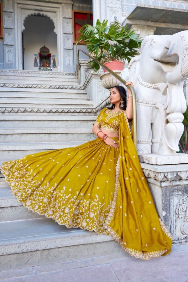 lnb - 1415   lnb 1415 thread embroidery work haldi special lehenga supplier surat 3 2025 06 02 16 03 49.jpg lnb 1415 thread embroidery work haldi special lehenga supplier surat Catalogue Name : 2nd Jun 2025 Name of Product : lnb - 1415  No of Design : 1 Piece (MOQ : 1 Set) Product Rate Per Piece : ₹ 1800 / Per Piece Product Full Catalogue Rate : ₹ 1800 (GST Extra) Full Catalogue Weight : 1 KG Product Type & Size: semi stitched Product Details: 
					 Wedding Collection 2025

A warm embrace of mustard and artistry 
 
LNB1415MST

Lehenga (Stitched)
Lehenga Fabric :  Vichitra Silk 
Lehenga work : Sequins and Thread Embroidery Work 
Lehenga Waist : SUPPORTED UP TO 42
Lehenga Closer : Drawstring with Zip 
Stitching : Stitched With Canvas and Can Can 
Length : 41
Flair : 3.5 Meter
Inner : Micro Cotton

Blouse (Unstitched)
Blouse Fabric :  Vichitra Silk 
Blouse Work : Sequins and Thread Embroidery Work 
Blouse Length : 1 Meter 

Dupatta
Dupatta Fabric :  Vichitra Silk   
Dupatta Work : Sequins and Thread Embroidery Work  Lace Border With Sequins Butties All Over  
Dupatta Length : 2.4 Meter

Package Contain: Lehenga, Blouse, Dupatta, Drawstring With Zip

Weight : 1.650 Kg

Price : 1800